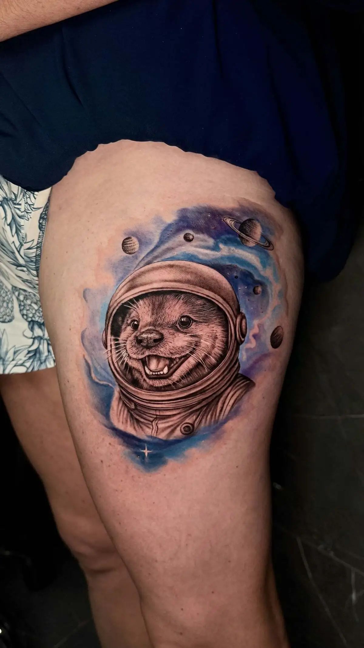 astronaut otter watercolor realism thigh tattoo