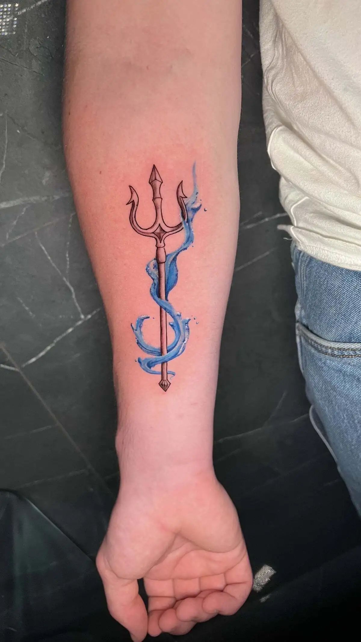trident linework splash forearm tattoo