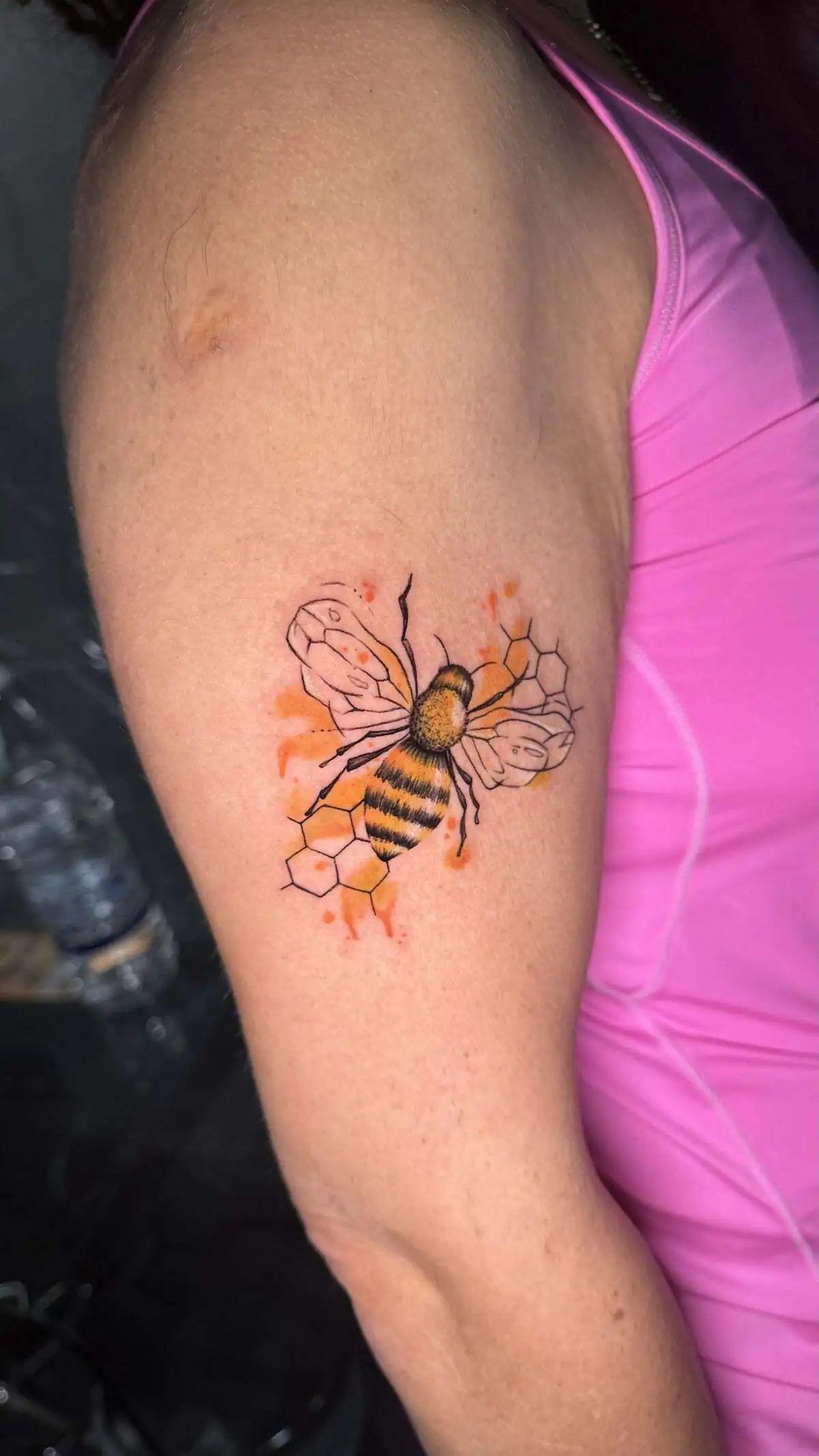 bee honeycomb watercolor upper arm tattoo