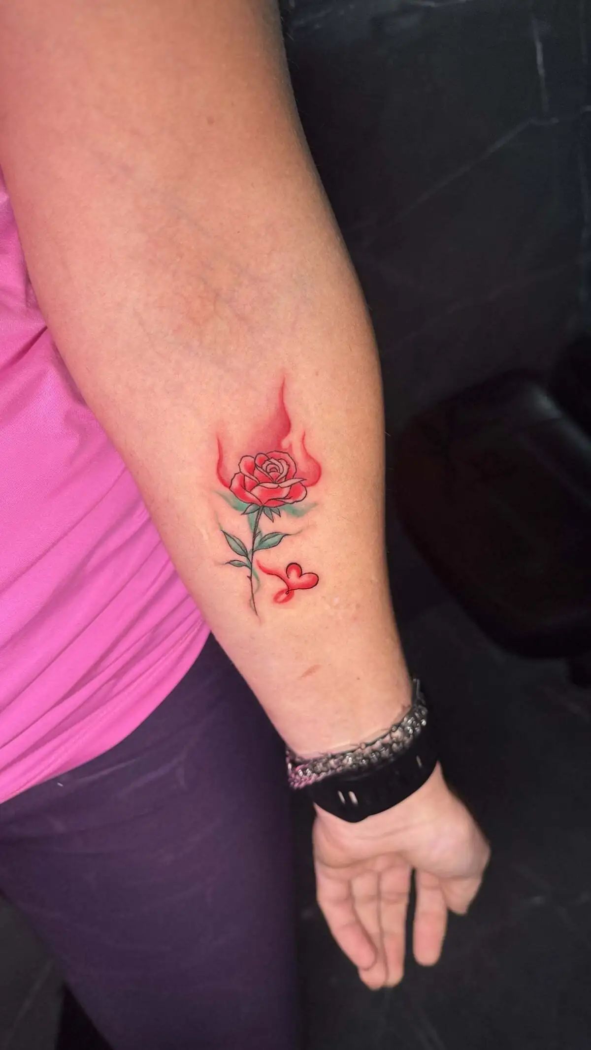 minimal rose flame accent forearm tattoo