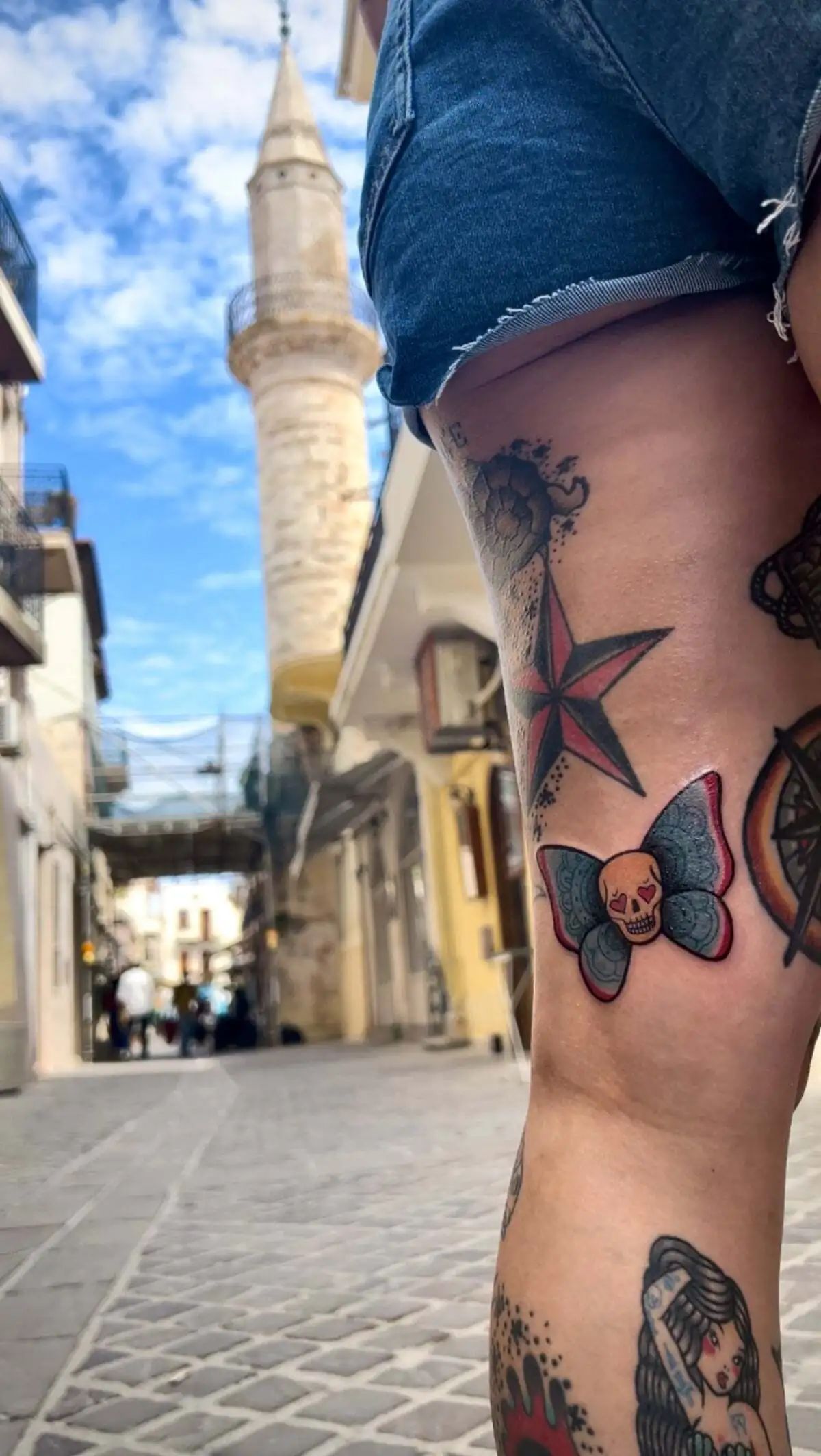 traditional butterfly skull thigh tattoo