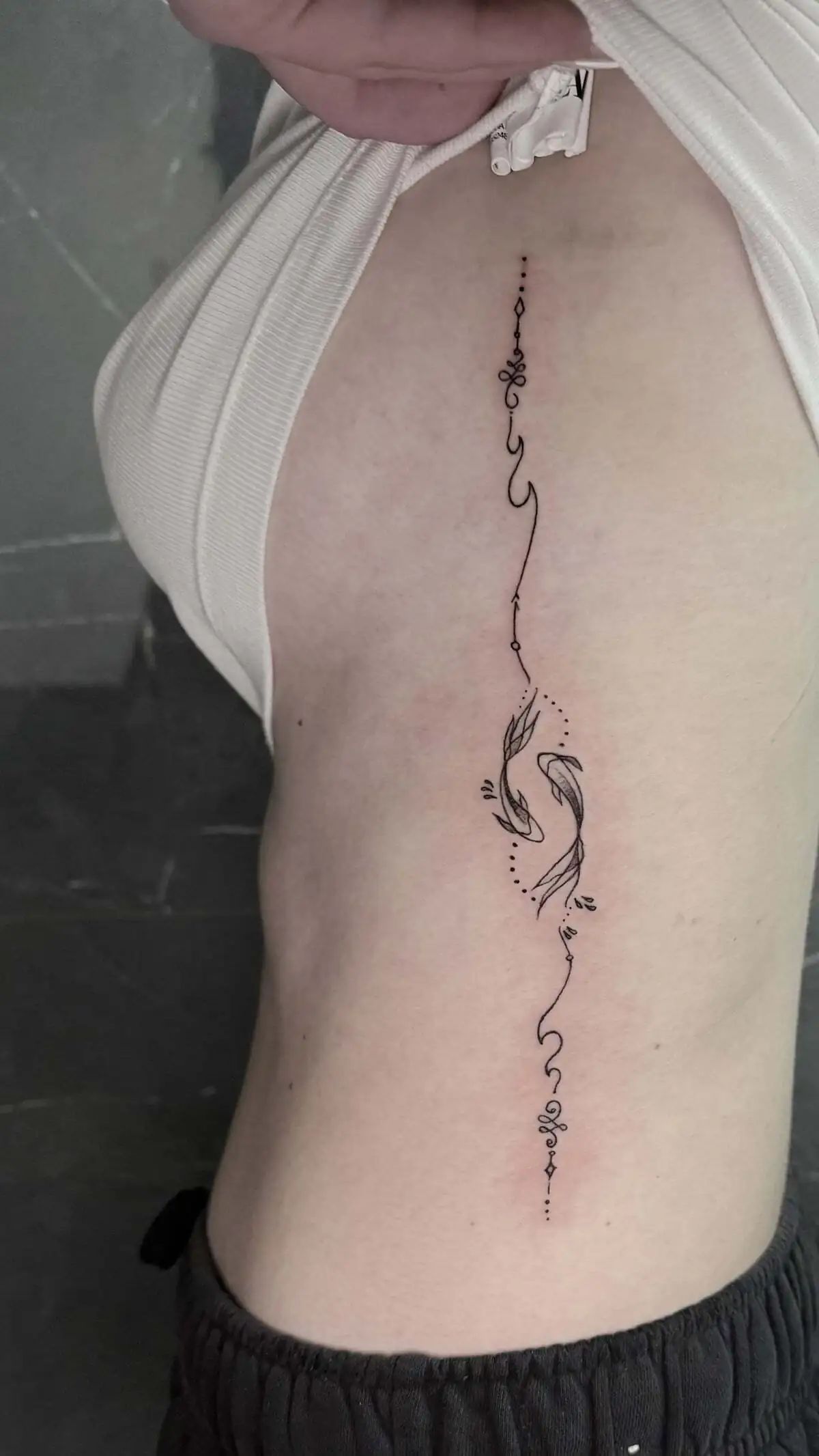 decorative linework fish side torso tattoo