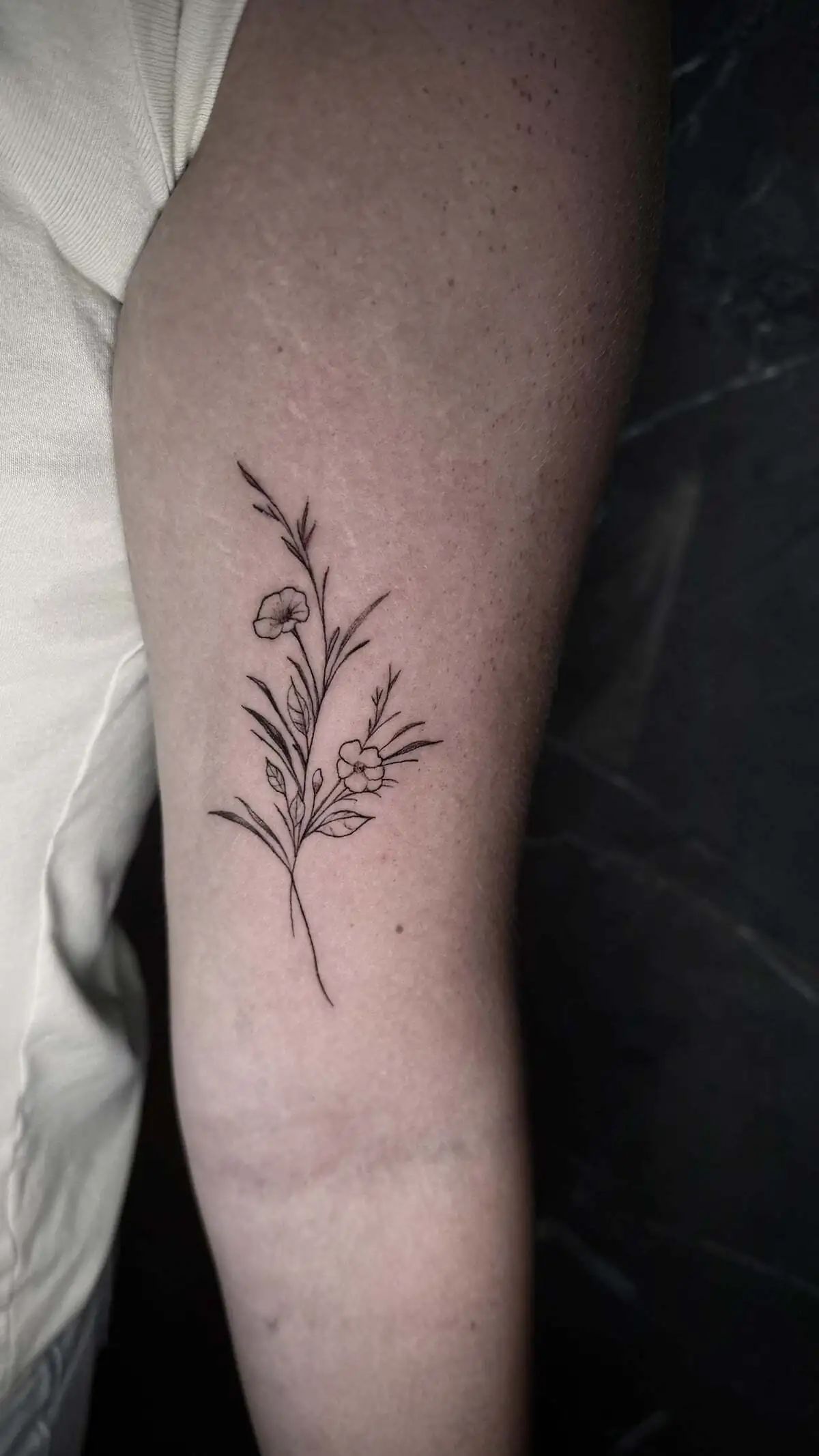 wildflower fine line forearm tattoo