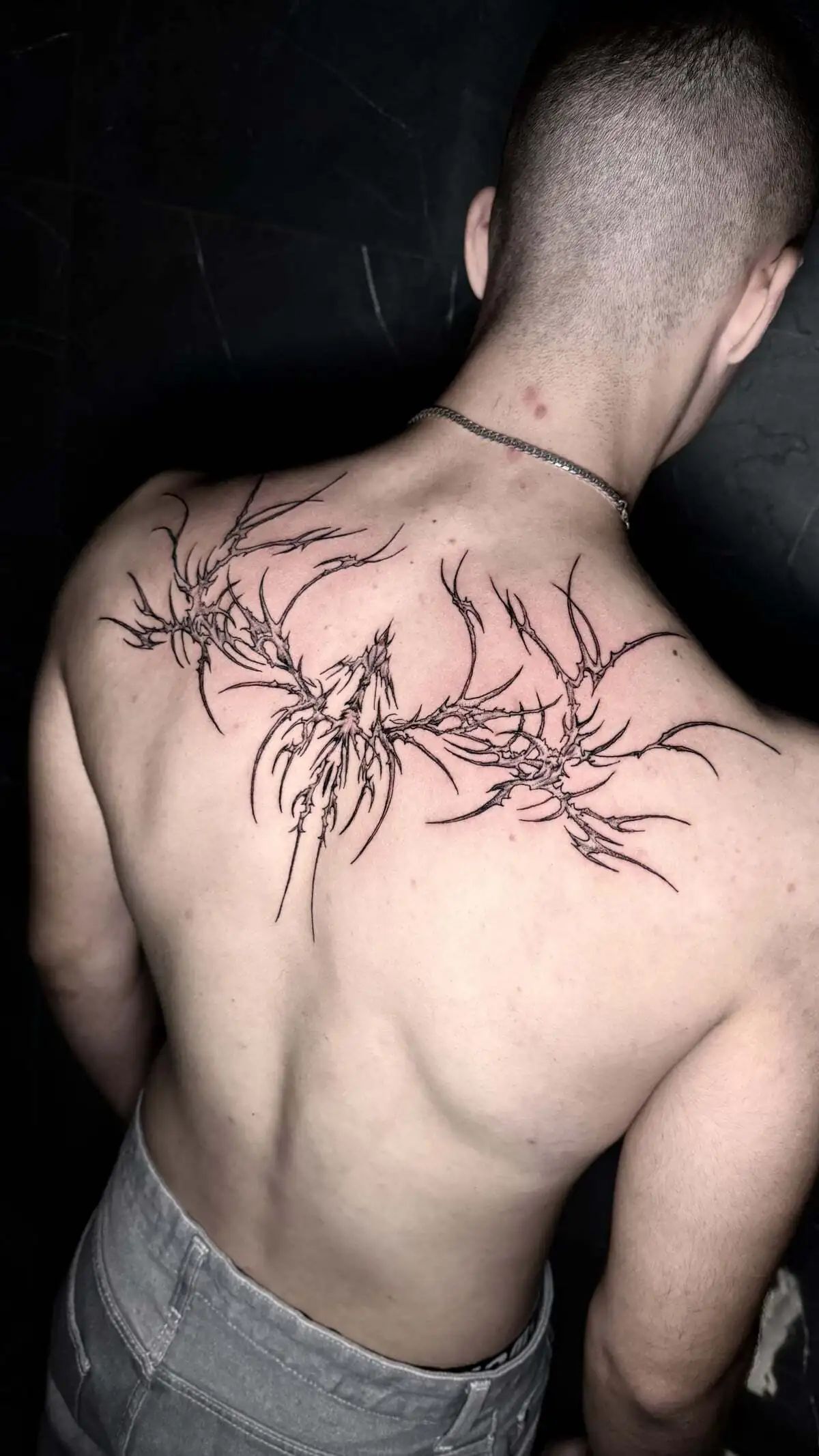 abstract thorn branch dragon back tattoo