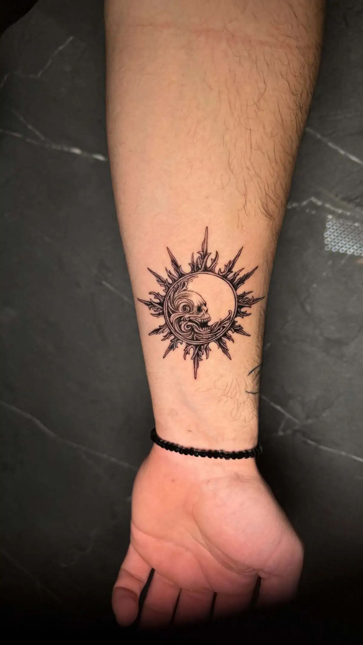 sun moon skull micro realism forearm tattoo