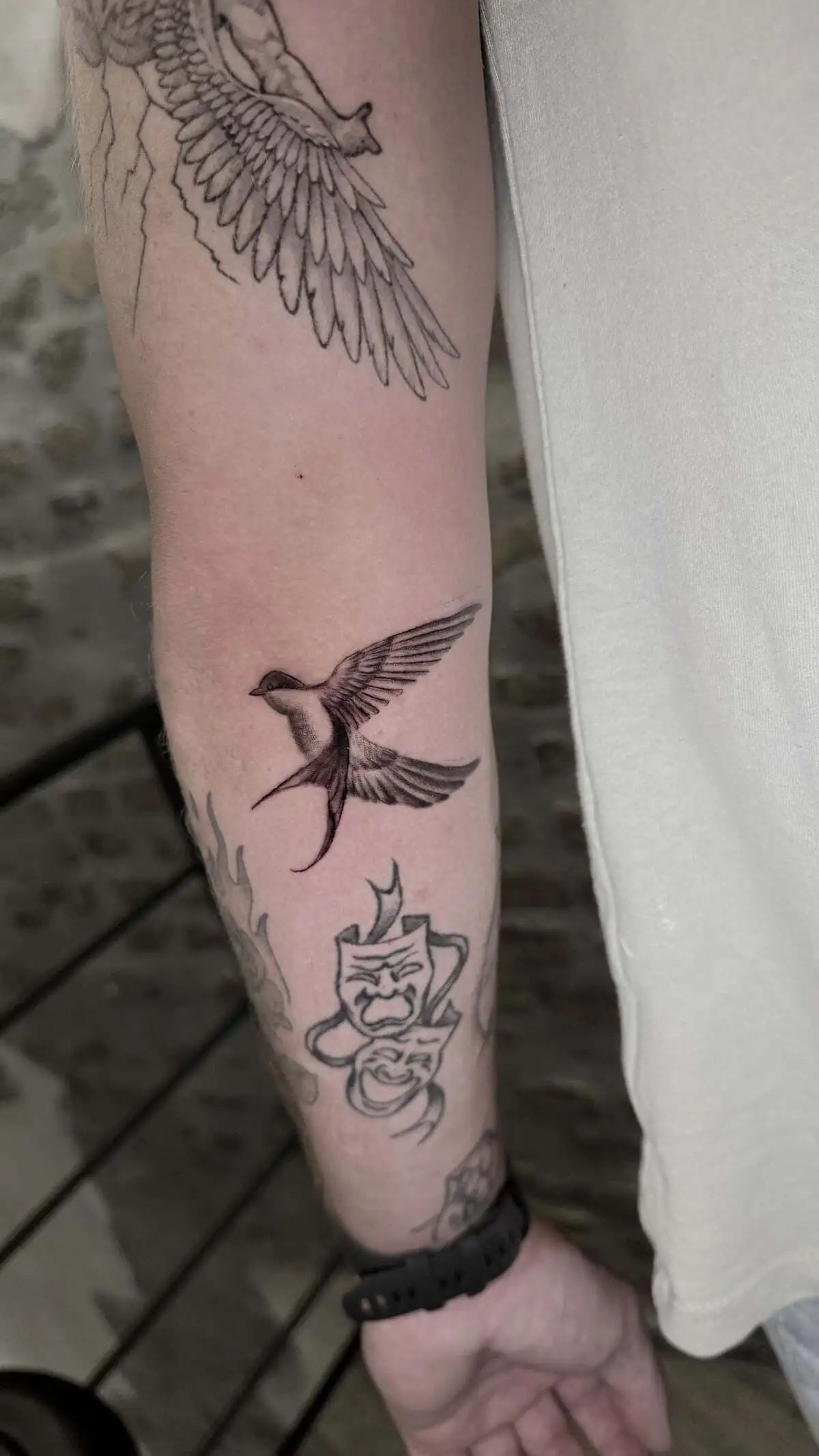 flying swallow bird micro realism forearm tattoo