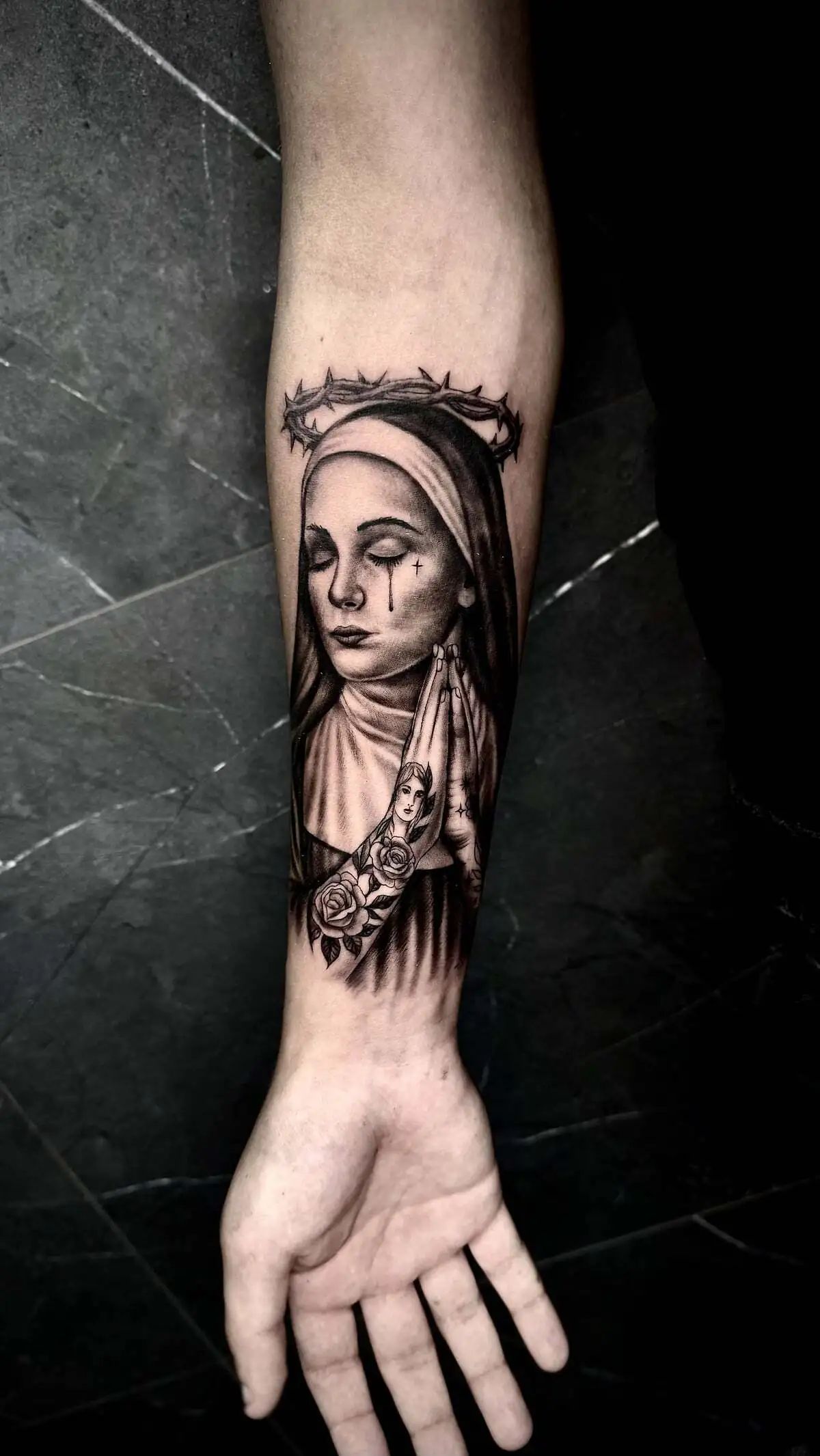 praying nun crown of thorns forearm tattoo