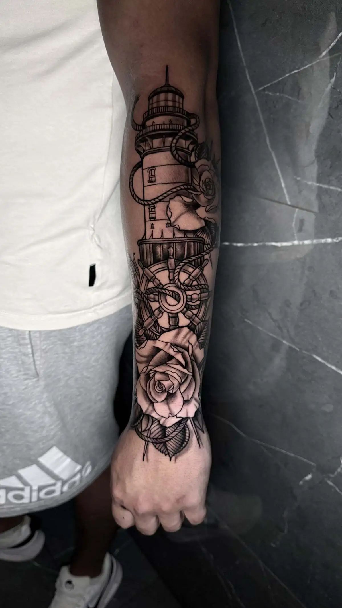 lighthouse ship wheel rose forearm tattoo